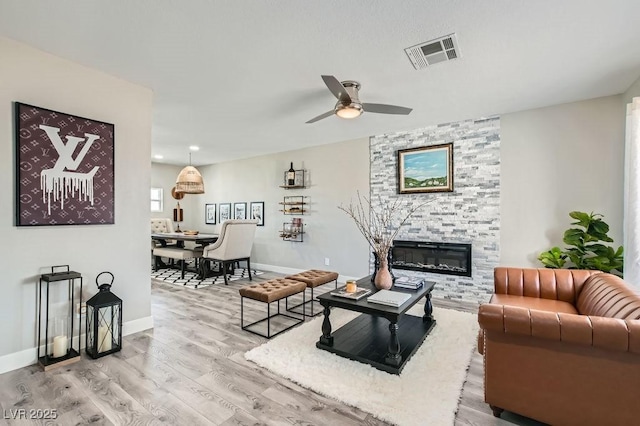 445 Concord Way, Henderson, NV 89015 - living area featuring a fireplace, light wood-style flooring, ceiling fan, and baseboards