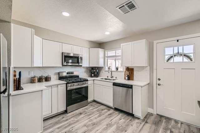445 Concord Way, Henderson, NV 89015 - kitchen featuring appliances with stainless steel finishes, a sink, plenty of natural light, light countertops, and a textured ceiling