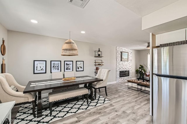 445 Concord Way, Henderson, NV 89015 - dining area featuring light wood-type flooring, ceiling fan, baseboards, a fireplace, and recessed lighting