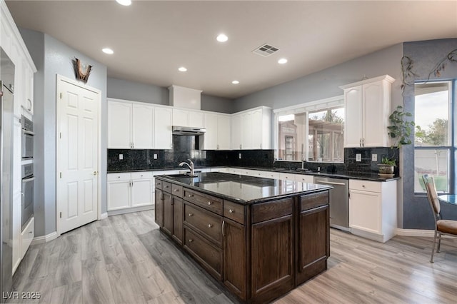 5210 Villa Dante Ave, Las Vegas, NV 89141 - kitchen featuring stainless steel dishwasher, healthy amount of natural light, white cabinets, and recessed lighting