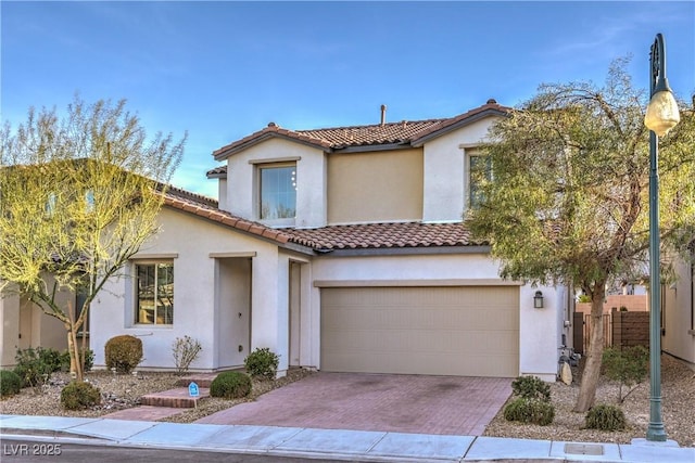 3213 Molinos Dr, Las Vegas, NV 89141 - mediterranean / spanish-style house featuring decorative driveway, stucco siding, a tile roof, and a garage