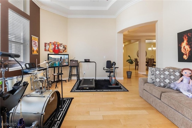 7567 Desertscape Ave, Las Vegas, NV 89178 - workout area with wood finished floors, arched walkways, a chandelier, crown molding, and a tray ceiling