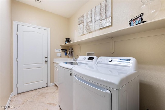 7567 Desertscape Ave, Las Vegas, NV 89178 - washroom featuring washer and dryer, cabinet space, baseboards, and light tile patterned floors