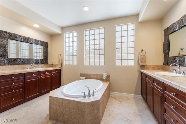 7567 Desertscape Ave, Las Vegas, NV 89178 - bathroom featuring a bath, backsplash, plenty of natural light, two vanities, and recessed lighting