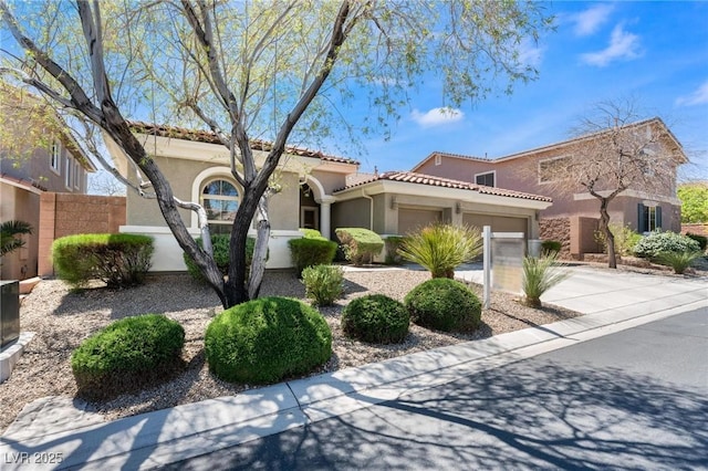 7567 Desertscape Ave, Las Vegas, NV 89178 - mediterranean / spanish house with stucco siding, a garage, driveway, and a tile roof