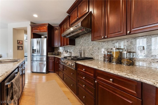 7567 Desertscape Ave, Las Vegas, NV 89178 - kitchen featuring under cabinet range hood, stainless steel appliances, decorative backsplash, light stone counters, and recessed lighting
