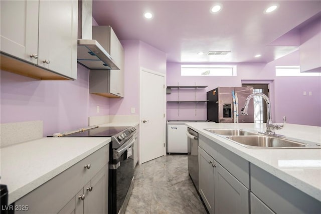 2807 Hermosa St, Las Vegas, NV 89169 - kitchen featuring appliances with stainless steel finishes, wall chimney range hood, a sink, gray cabinets, and recessed lighting