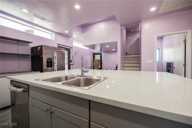 2807 Hermosa St, Las Vegas, NV 89169 - kitchen with stainless steel appliances, a sink, gray cabinetry, light stone counters, and recessed lighting