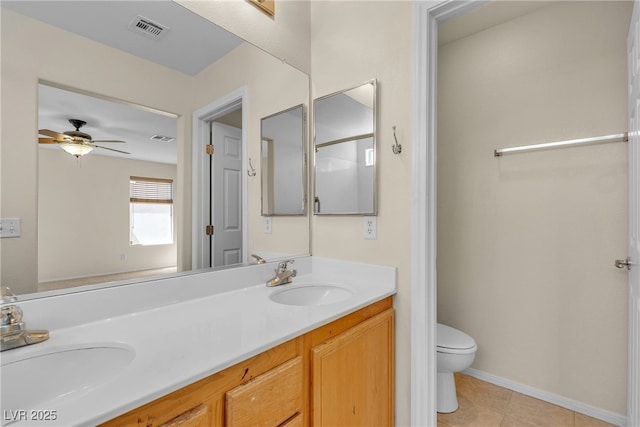 10791 Silver Lace Ln, Las Vegas, NV 89135 - bathroom with toilet, ceiling fan, double vanity, tile patterned flooring, and baseboards