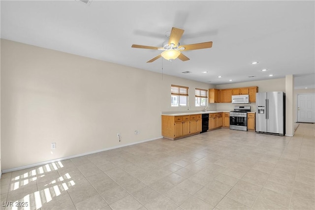 10791 Silver Lace Ln, Las Vegas, NV 89135 - kitchen with appliances with stainless steel finishes, light countertops, a ceiling fan, recessed lighting, and baseboards