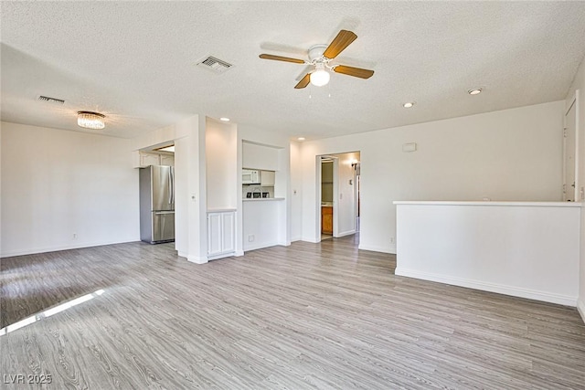 4083 Nook Way Unit D, Las Vegas, NV 89103 - unfurnished living room featuring a textured ceiling, light wood-type flooring, ceiling fan, recessed lighting, and baseboards