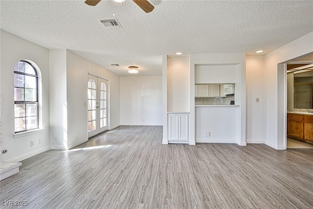 4083 Nook Way Unit D, Las Vegas, NV 89103 - unfurnished living room with wood finished floors, a textured ceiling, ceiling fan, a sink, and baseboards
