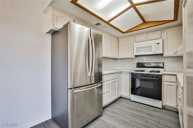 4083 Nook Way Unit D, Las Vegas, NV 89103 - kitchen featuring white appliances, light wood-type flooring, light countertops, and baseboards