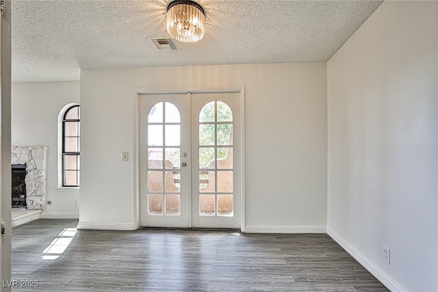4083 Nook Way Unit D, Las Vegas, NV 89103 - foyer entrance with a textured ceiling, wood finished floors, a chandelier, baseboards, and french doors