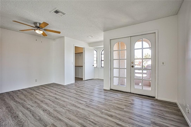 4083 Nook Way Unit D, Las Vegas, NV 89103 - unfurnished room featuring french doors, wood finished floors, a ceiling fan, and a textured ceiling