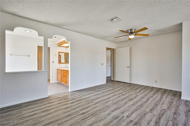 4083 Nook Way Unit D, Las Vegas, NV 89103 - unfurnished room with wood finished floors, a ceiling fan, a textured ceiling, and baseboards
