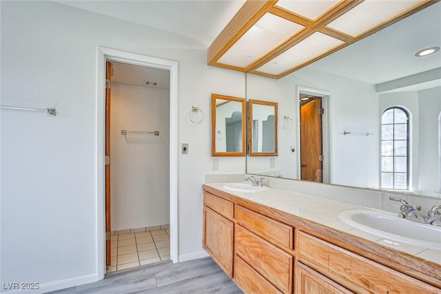 4083 Nook Way Unit D, Las Vegas, NV 89103 - bathroom featuring wood finished floors, double vanity, and baseboards