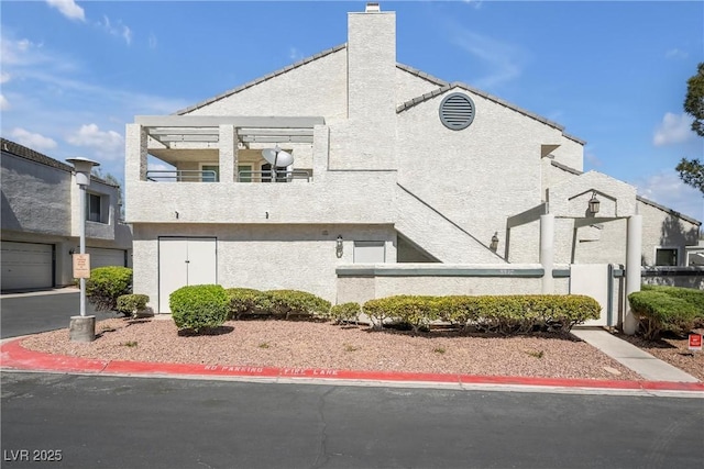 8932 Antioch Way, Las Vegas, NV 89117 - view of home's exterior with stucco siding and a chimney