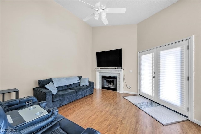8932 Antioch Way, Las Vegas, NV 89117 - living room with lofted ceiling, a ceiling fan, wood finished floors, french doors, and a fireplace