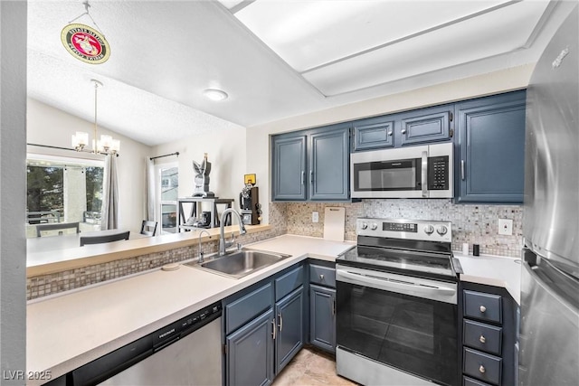 8932 Antioch Way, Las Vegas, NV 89117 - kitchen featuring appliances with stainless steel finishes, a sink, a chandelier, decorative backsplash, and light countertops