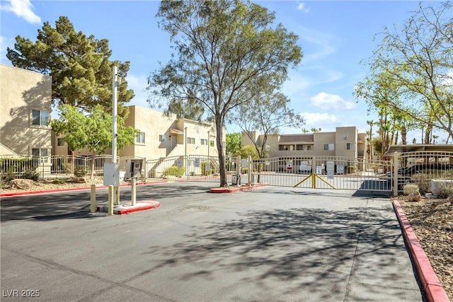 1832 N Decatur Blvd Unit 104, Las Vegas, NV 89108 - view of asphalt street featuring a residential view, a gate, curbs, and a gated entry