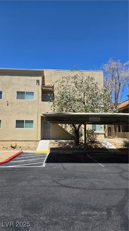 1832 N Decatur Blvd Unit 104, Las Vegas, NV 89108 - view of building exterior featuring covered parking