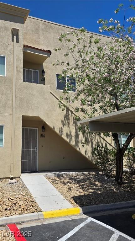 1832 N Decatur Blvd Unit 104, Las Vegas, NV 89108 - view of property featuring uncovered parking