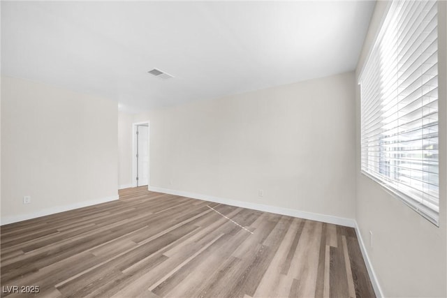 1832 N Decatur Blvd Unit 104, Las Vegas, NV 89108 - spare room featuring wood finished floors, plenty of natural light, and baseboards