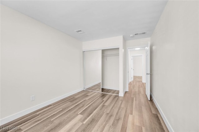 1832 N Decatur Blvd Unit 104, Las Vegas, NV 89108 - unfurnished bedroom featuring light wood finished floors, a closet, and baseboards