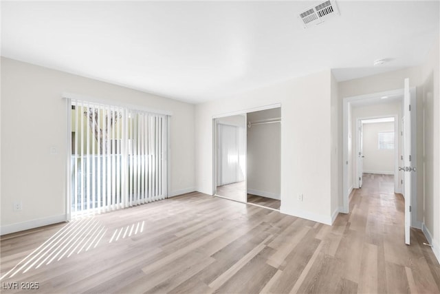 1832 N Decatur Blvd Unit 104, Las Vegas, NV 89108 - unfurnished bedroom featuring light wood-style floors, baseboards, and a closet