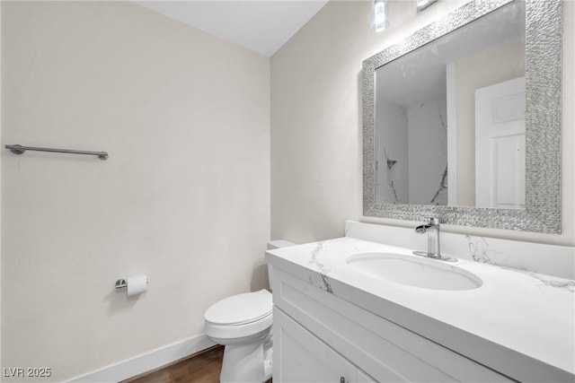 1832 N Decatur Blvd Unit 104, Las Vegas, NV 89108 - bathroom featuring toilet, vanity, baseboards, and wood finished floors