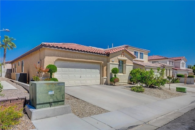 5548 Spearfish Lake Ct, Las Vegas, NV 89148 - mediterranean / spanish-style home featuring a tile roof, central AC, a garage, stucco siding, and concrete driveway