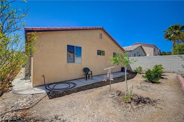 5548 Spearfish Lake Ct, Las Vegas, NV 89148 - rear view of property featuring stucco siding and a patio