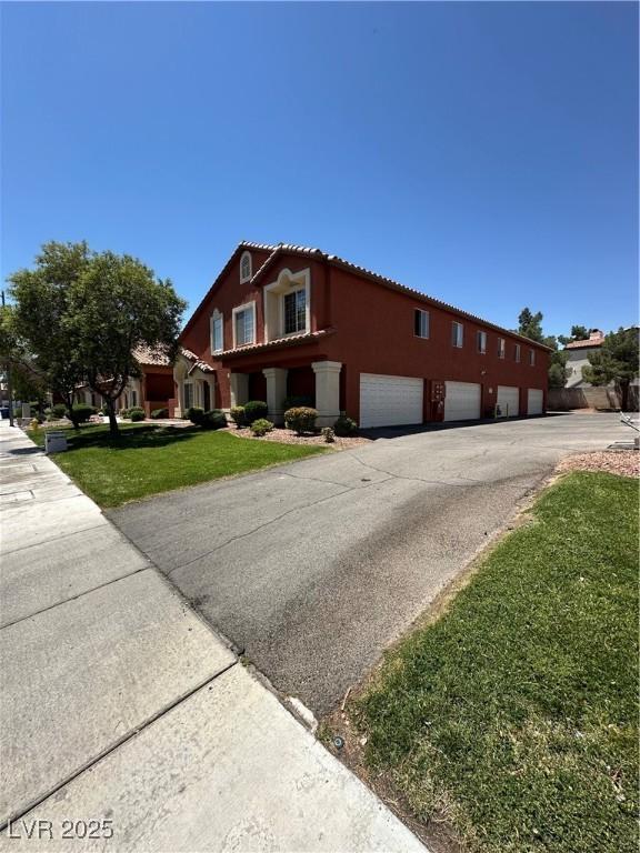 805 Desert Oak Ct, Las Vegas, NV 89147 - view of home's exterior featuring driveway, a lawn, stucco siding, a tile roof, and a garage