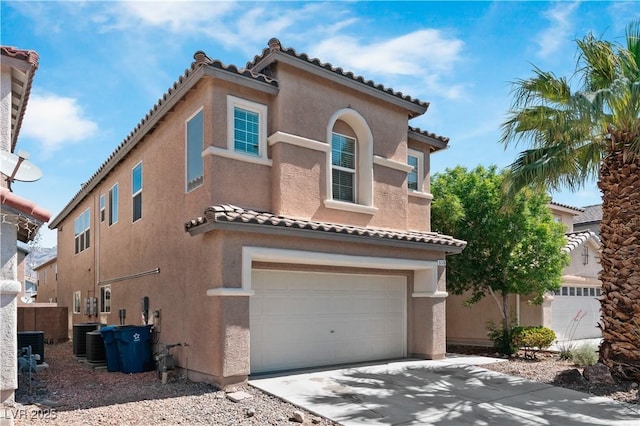 5116 Iron Crossing Ave, Las Vegas, NV 89131 - mediterranean / spanish home with stucco siding, a tiled roof, an attached garage, concrete driveway, and cooling unit