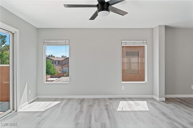 5116 Iron Crossing Ave, Las Vegas, NV 89131 - unfurnished room featuring wood finished floors, healthy amount of natural light, ceiling fan, and baseboards