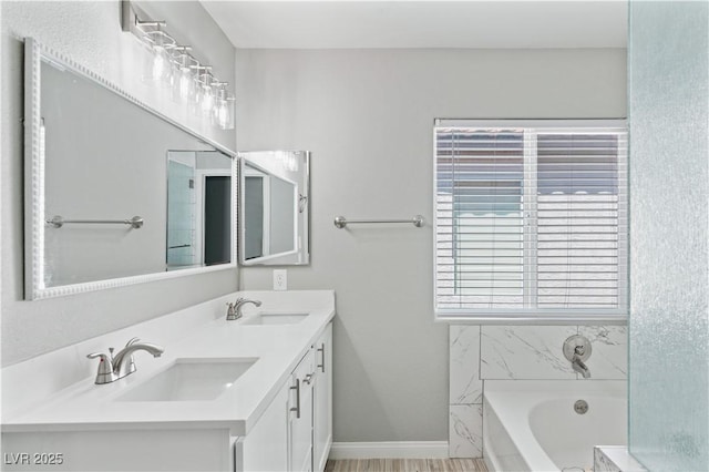 5116 Iron Crossing Ave, Las Vegas, NV 89131 - bathroom with a tub to relax in, double vanity, and baseboards