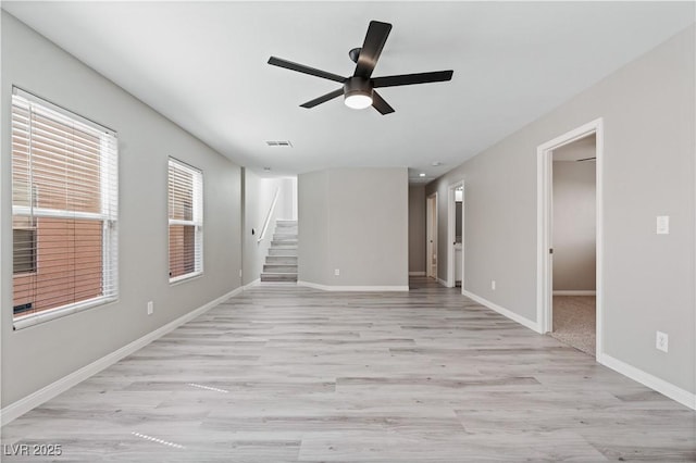 5116 Iron Crossing Ave, Las Vegas, NV 89131 - empty room with a ceiling fan, light wood-type flooring, baseboards, and stairs