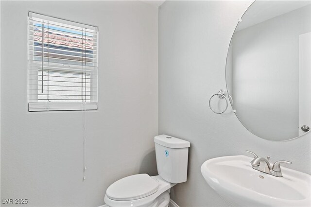 5116 Iron Crossing Ave, Las Vegas, NV 89131 - bathroom featuring a sink, toilet, and baseboards