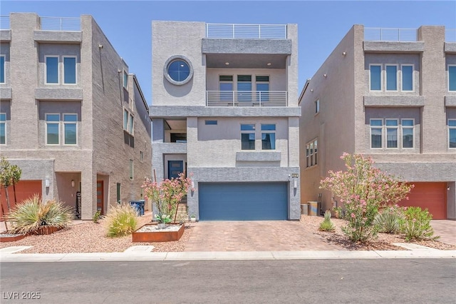 8076 Haywood Estate Ave, Las Vegas, NV 89113 - contemporary house featuring an attached garage, stucco siding, and driveway
