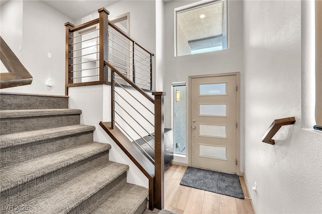 8076 Haywood Estate Ave, Las Vegas, NV 89113 - foyer featuring stairway, wood finished floors, plenty of natural light, a textured wall, and baseboards