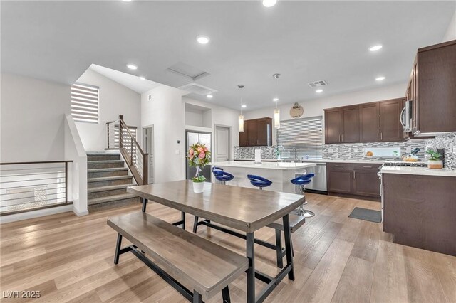 8076 Haywood Estate Ave, Las Vegas, NV 89113 - dining space with light wood-type flooring, recessed lighting, and stairway