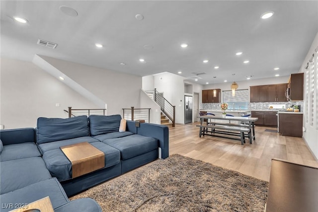 8076 Haywood Estate Ave, Las Vegas, NV 89113 - living area featuring recessed lighting, light wood-style flooring, and stairs