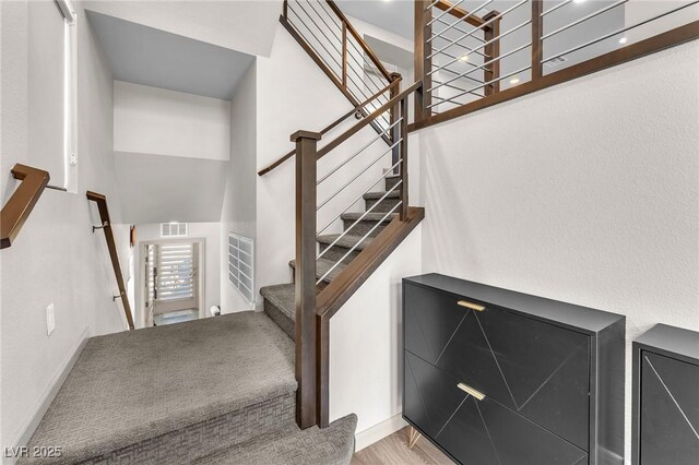 8076 Haywood Estate Ave, Las Vegas, NV 89113 - stairs with a high ceiling and wood finished floors