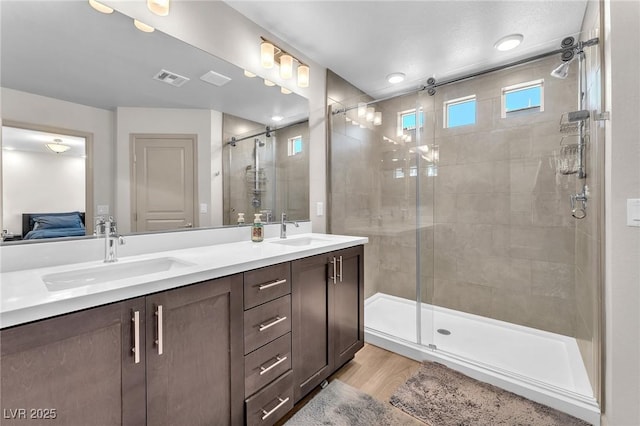 8076 Haywood Estate Ave, Las Vegas, NV 89113 - ensuite bathroom with a stall shower, double vanity, and wood finished floors