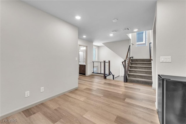 8076 Haywood Estate Ave, Las Vegas, NV 89113 - unfurnished living room with light wood-style floors, recessed lighting, baseboards, and stairway