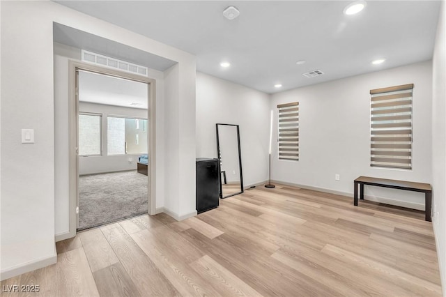 8076 Haywood Estate Ave, Las Vegas, NV 89113 - unfurnished living room with light wood-style flooring, recessed lighting, and baseboards
