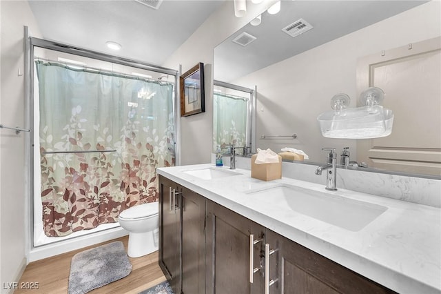 8076 Haywood Estate Ave, Las Vegas, NV 89113 - full bathroom with toilet, double vanity, curtained shower, and wood finished floors