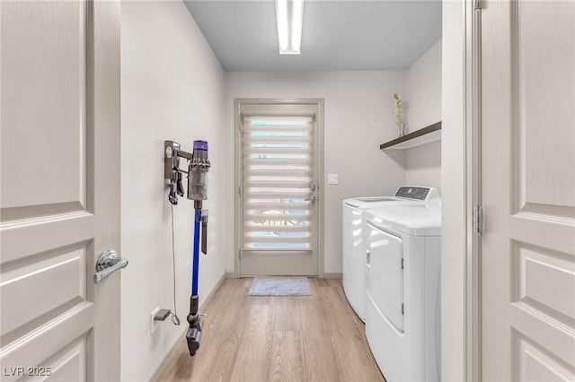 8076 Haywood Estate Ave, Las Vegas, NV 89113 - laundry area featuring light wood-type flooring, washing machine and clothes dryer, and baseboards