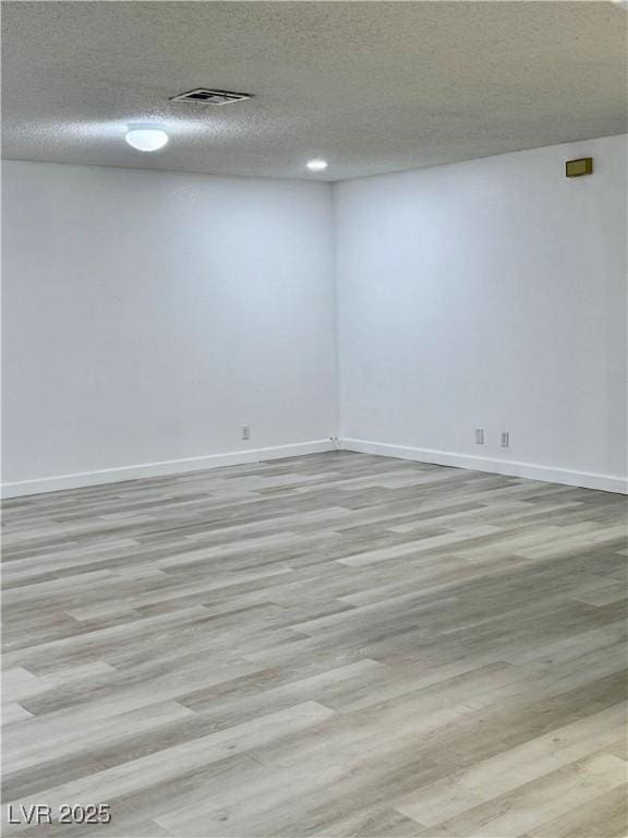 1320 Driscoll Dr Unit 202, Las Vegas, NV 89128 - unfurnished room with wood finished floors, baseboards, and a textured ceiling